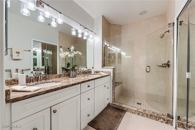 9241 Spring Run Blvd Unit 2202, Estero, FL 34135 - bathroom with a shower stall, double vanity, a sink, and tile patterned flooring