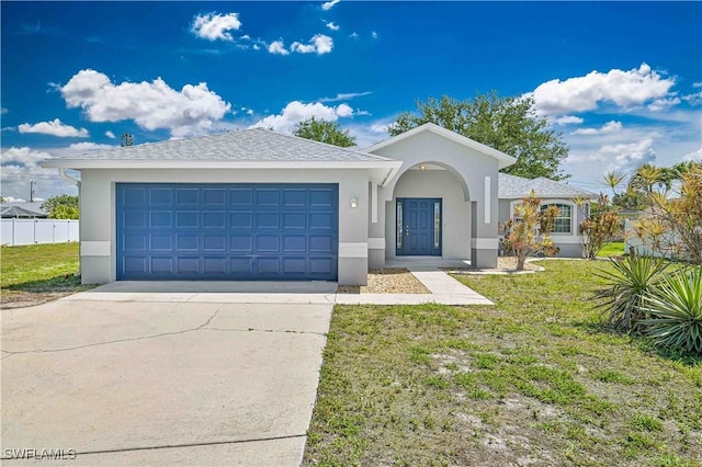 3831 Pelican Blvd, Cape Coral, FL 33914 - single story home with concrete driveway, stucco siding, a garage, and a front lawn