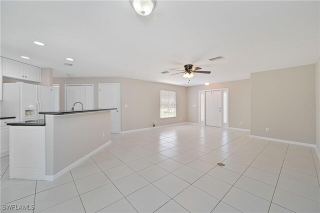 3831 Pelican Blvd, Cape Coral, FL 33914 - unfurnished living room with light tile patterned flooring, ceiling fan, baseboards, and visible vents