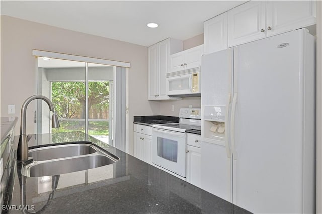 3831 Pelican Blvd, Cape Coral, FL 33914 - kitchen featuring white appliances, white cabinetry, a sink, and dark stone countertops