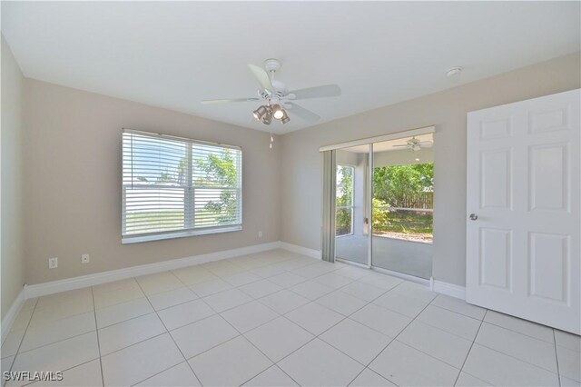3831 Pelican Blvd, Cape Coral, FL 33914 - spare room featuring a healthy amount of sunlight, light tile patterned flooring, baseboards, and a ceiling fan