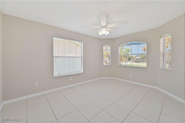 3831 Pelican Blvd, Cape Coral, FL 33914 - unfurnished room with baseboards, a ceiling fan, and light tile patterned flooring