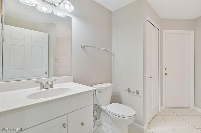 3831 Pelican Blvd, Cape Coral, FL 33914 - bathroom featuring toilet, a closet, vanity, and tile patterned flooring