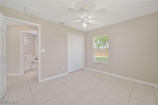 3831 Pelican Blvd, Cape Coral, FL 33914 - unfurnished bedroom featuring a closet, baseboards, light tile patterned floors, visible vents, and ceiling fan