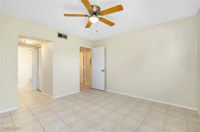 unfurnished room featuring a ceiling fan, baseboards, and visible vents