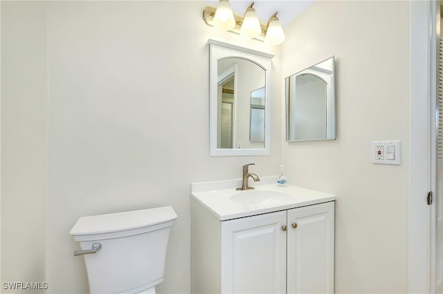 bathroom featuring toilet and vanity