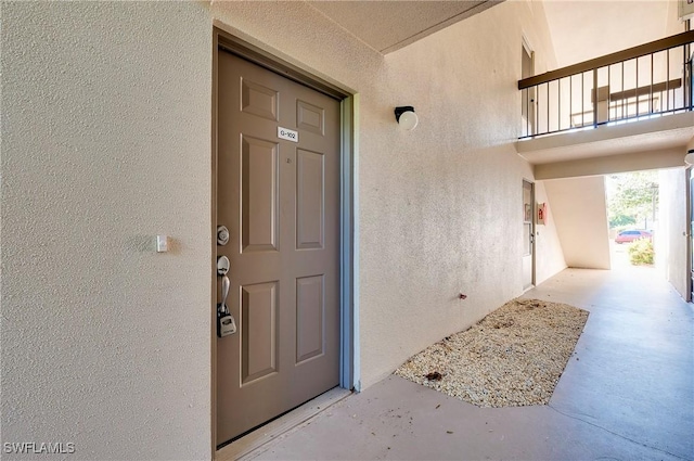 entrance to property featuring stucco siding