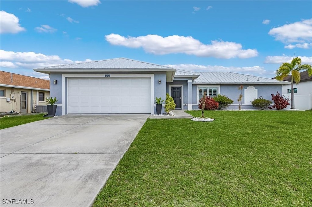 single story home with an attached garage, driveway, metal roof, and stucco siding
