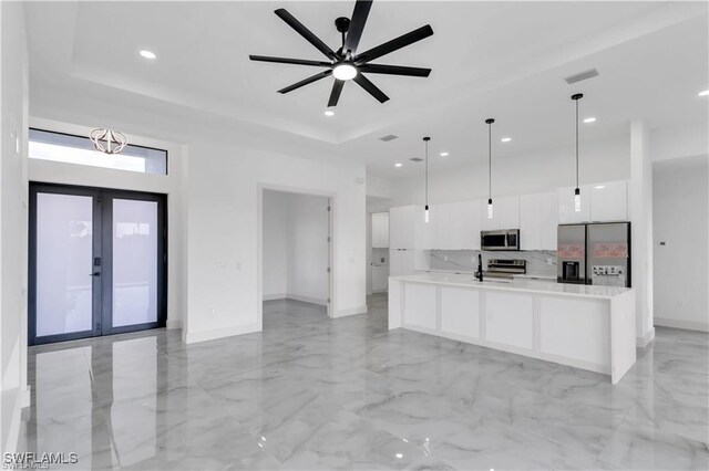 kitchen featuring modern cabinets, white cabinetry, marble finish floor, light countertops, and stainless steel appliances