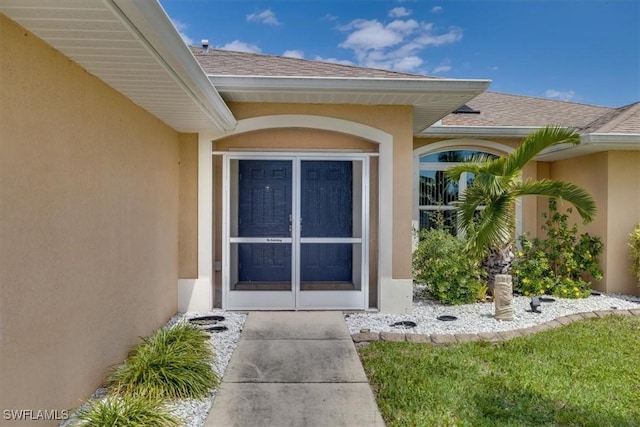 605 SE 22nd St, Cape Coral, FL 33990 - property entrance featuring a shingled roof and stucco siding
