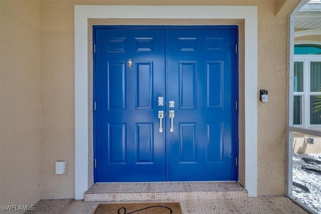 605 SE 22nd St, Cape Coral, FL 33990 - view of exterior entry featuring stucco siding