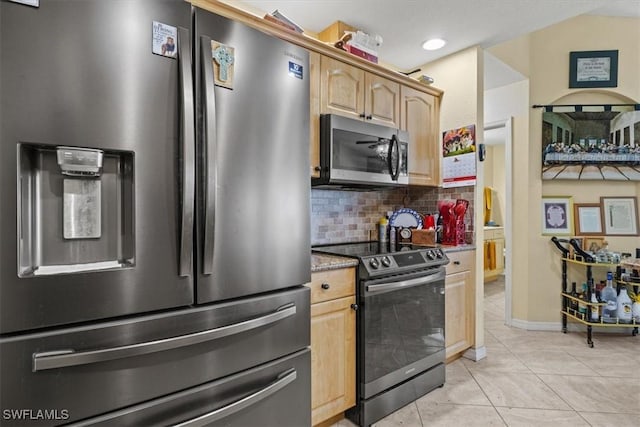 605 SE 22nd St, Cape Coral, FL 33990 - kitchen with light stone counters, light tile patterned flooring, stainless steel appliances, decorative backsplash, and light brown cabinets