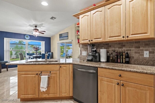 605 SE 22nd St, Cape Coral, FL 33990 - kitchen with stainless steel dishwasher, a peninsula, a sink, and decorative backsplash