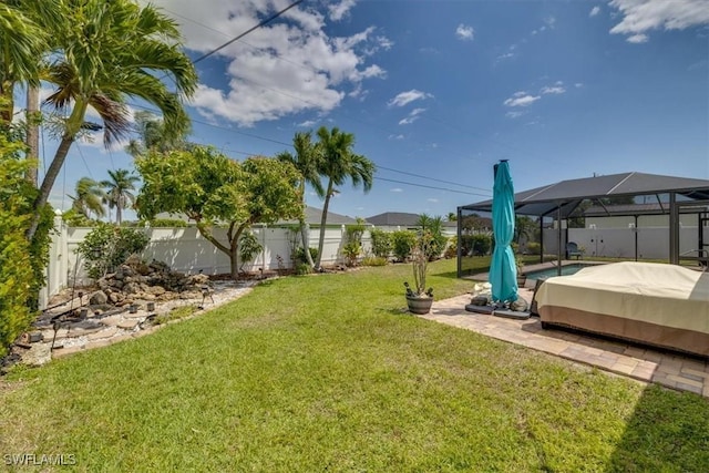 605 SE 22nd St, Cape Coral, FL 33990 - view of yard with a swimming pool, a fenced backyard, and glass enclosure