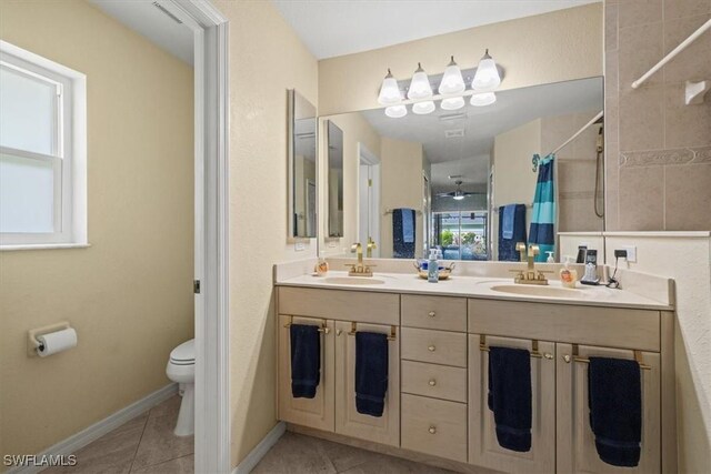 605 SE 22nd St, Cape Coral, FL 33990 - bathroom featuring a sink, tile patterned floors, toilet, and tiled shower