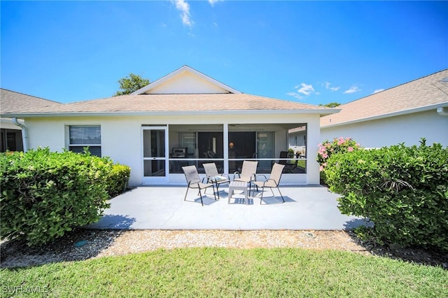 25431 Fairway Dunes Ct, Bonita Springs, FL 34135 - rear view of property featuring a sunroom, a patio, and stucco siding