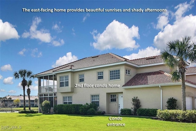 5600 Chelsey Ln Unit 201, Fort Myers, FL 33912 - rear view of house featuring a tiled roof, stucco siding, and a lawn
