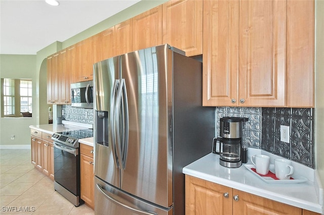 5600 Chelsey Ln Unit 201, Fort Myers, FL 33912 - kitchen with tasteful backsplash, baseboards, light countertops, light tile patterned flooring, and appliances with stainless steel finishes