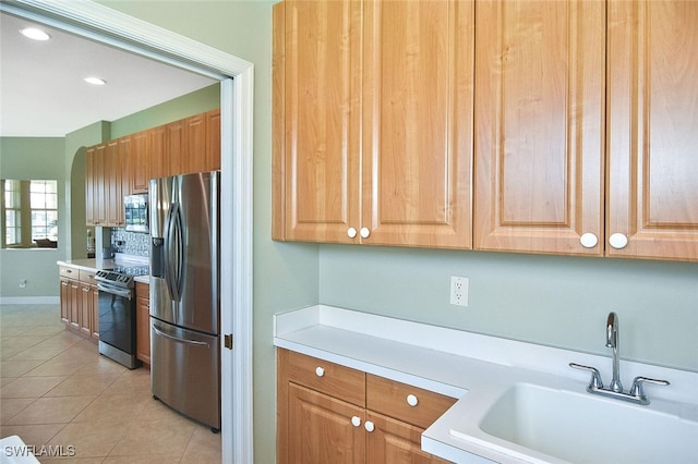5600 Chelsey Ln Unit 201, Fort Myers, FL 33912 - kitchen with light tile patterned floors, a sink, light countertops, recessed lighting, and stainless steel appliances