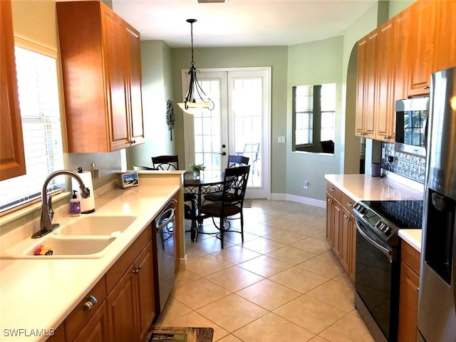 5600 Chelsey Ln Unit 201, Fort Myers, FL 33912 - kitchen featuring a sink, light countertops, appliances with stainless steel finishes, and pendant lighting
