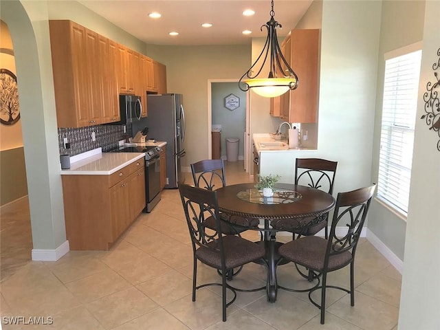 5600 Chelsey Ln Unit 201, Fort Myers, FL 33912 - kitchen with a sink, backsplash, light countertops, and appliances with stainless steel finishes