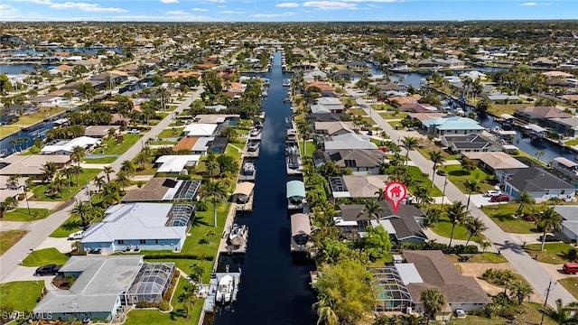 birds eye view of property featuring a water view and a residential view