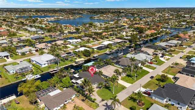 birds eye view of property with a water view and a residential view