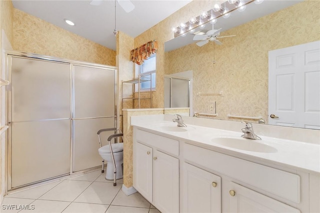 full bathroom featuring ceiling fan, a shower stall, a sink, tile patterned floors, and wallpapered walls
