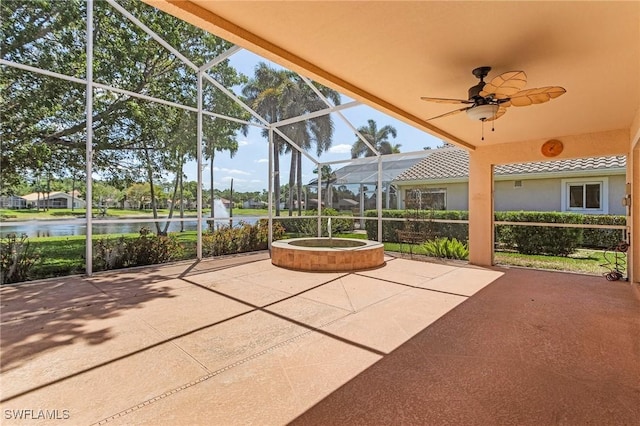 view of patio / terrace with a water view, a lanai, and ceiling fan