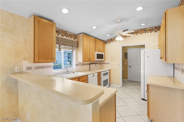 kitchen with a ceiling fan, light countertops, a sink, and white appliances