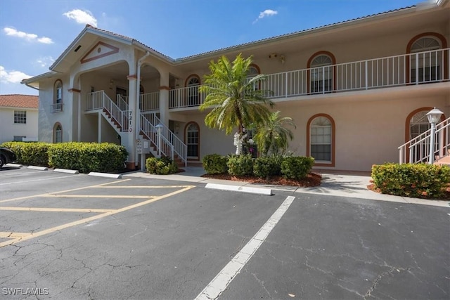 721 Mardel Dr Unit 602, Naples, FL 34104 - view of property with uncovered parking and stairs
