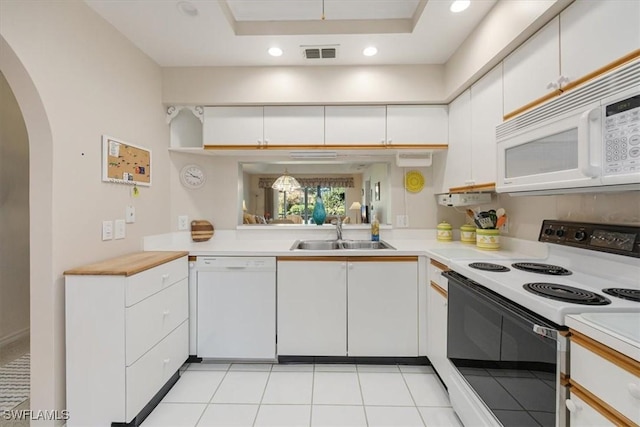 721 Mardel Dr Unit 602, Naples, FL 34104 - kitchen with light countertops, arched walkways, a sink, and white appliances