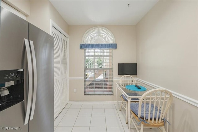 721 Mardel Dr Unit 602, Naples, FL 34104 - kitchen with stainless steel fridge with ice dispenser, tile patterned flooring, and baseboards
