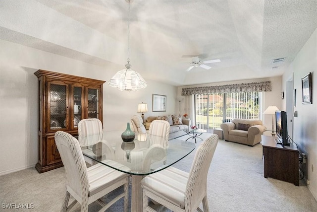 721 Mardel Dr Unit 602, Naples, FL 34104 - dining space featuring visible vents, a textured ceiling, a tray ceiling, ceiling fan with notable chandelier, and light colored carpet