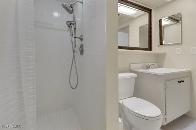 full bathroom with vanity, toilet, and tiled shower