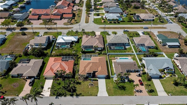 bird's eye view with a residential view and a water view