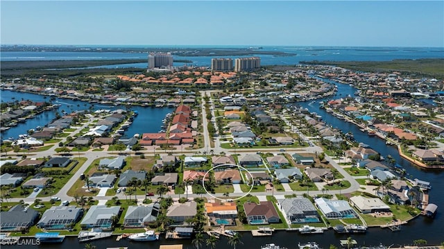 drone / aerial view featuring a water view and a residential view