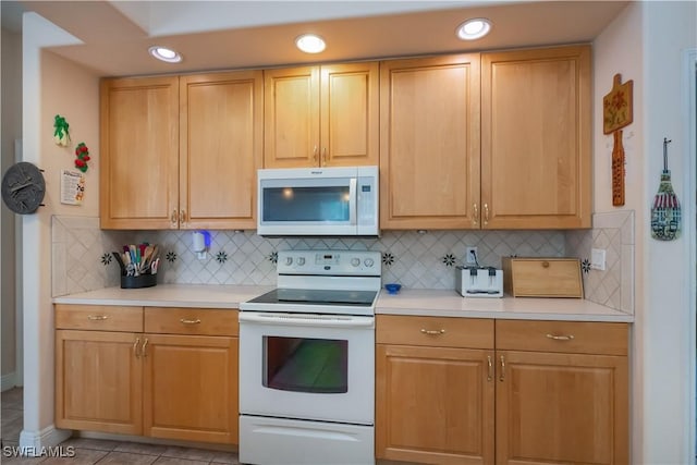 kitchen featuring light countertops, white appliances, recessed lighting, and backsplash