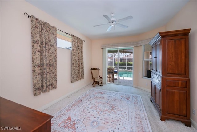 sitting room with baseboards, a healthy amount of sunlight, light colored carpet, and ceiling fan