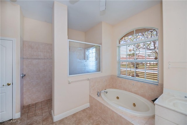 full bathroom with tile patterned floors, a jetted tub, vanity, a walk in shower, and baseboards