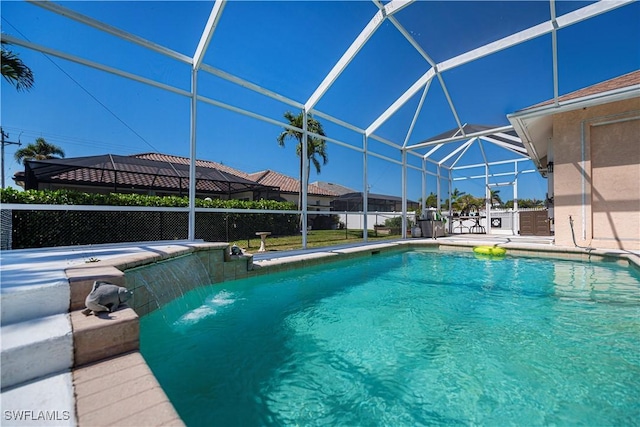 view of swimming pool with glass enclosure, a patio, and a fenced in pool