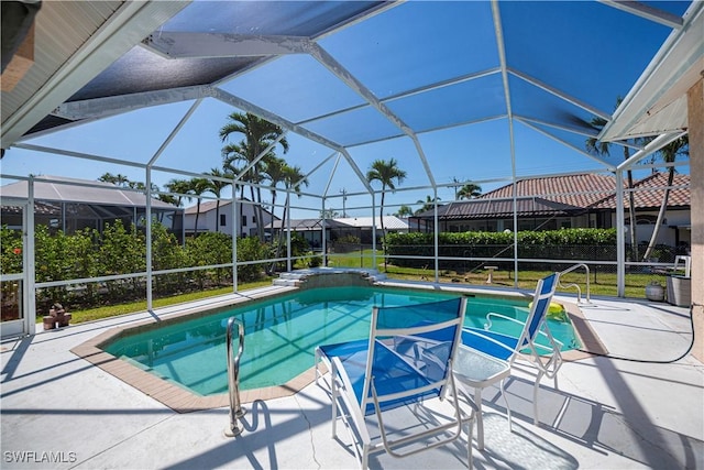 outdoor pool with a patio area and a lanai
