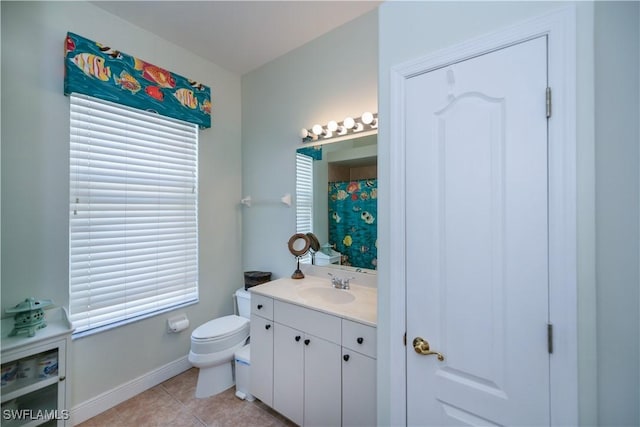 bathroom featuring toilet, vanity, tile patterned floors, and baseboards