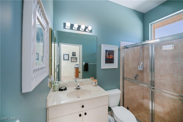 full bath featuring vanity, toilet, and a stall shower