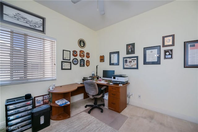 carpeted office space featuring baseboards