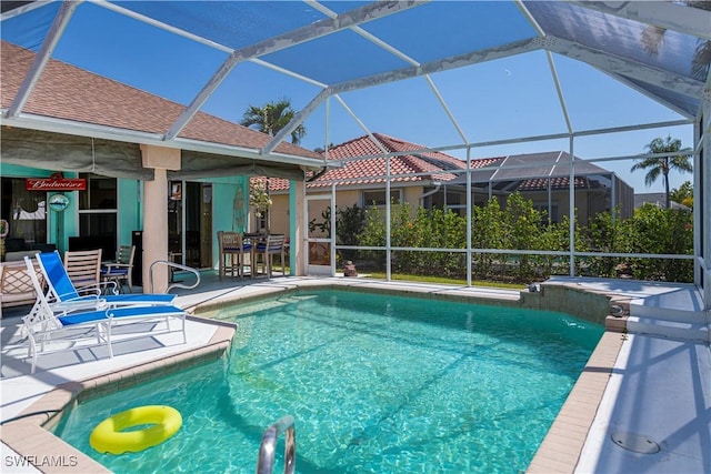 pool with a lanai and a patio