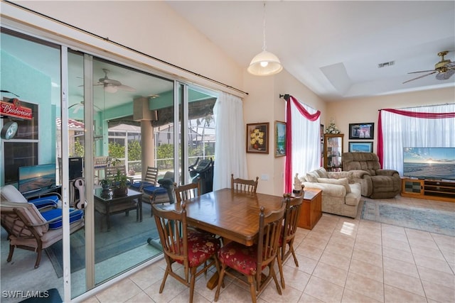 dining space featuring light tile patterned flooring, vaulted ceiling, visible vents, and ceiling fan