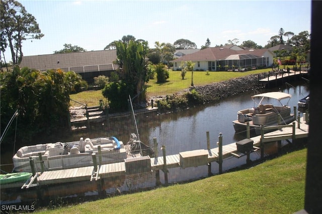 dock area featuring a lawn and a water view