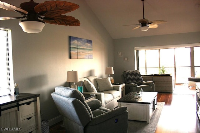 living area featuring a ceiling fan, wood finished floors, and vaulted ceiling