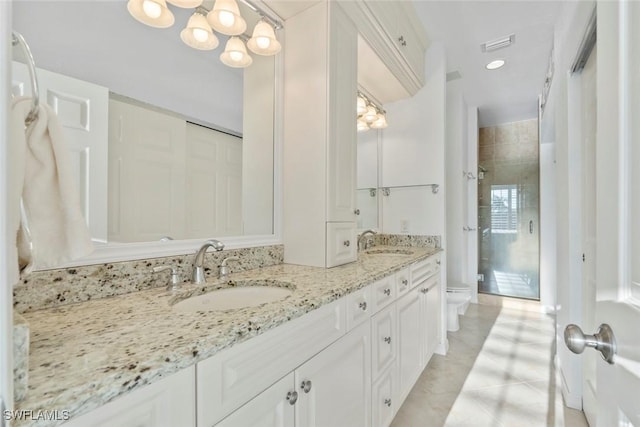 3570 Haldeman Creek Dr Unit 134, Naples, FL 34112 - bathroom featuring toilet, double vanity, a sink, and a shower stall